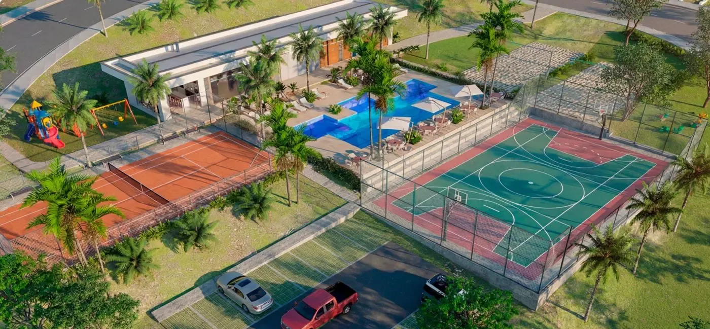 Vista aérea do conjunto de lazer: piscina, quadras de tênis e poliesportiva, playground e área gourmet — perspectiva ilustrativa
